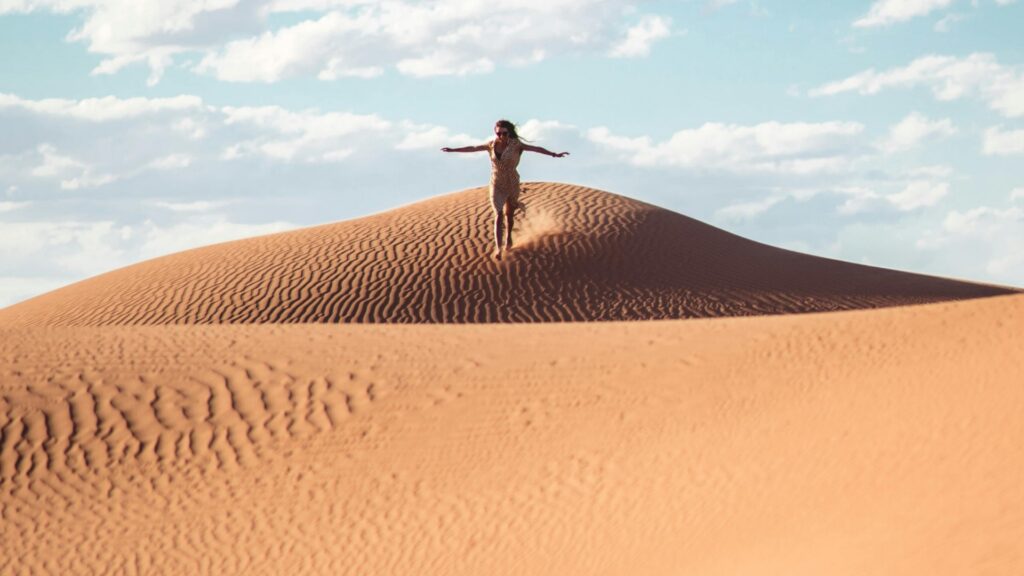 Desierto del Sahara en Marruecos con dunas doradas y campamento tradicional bereber.